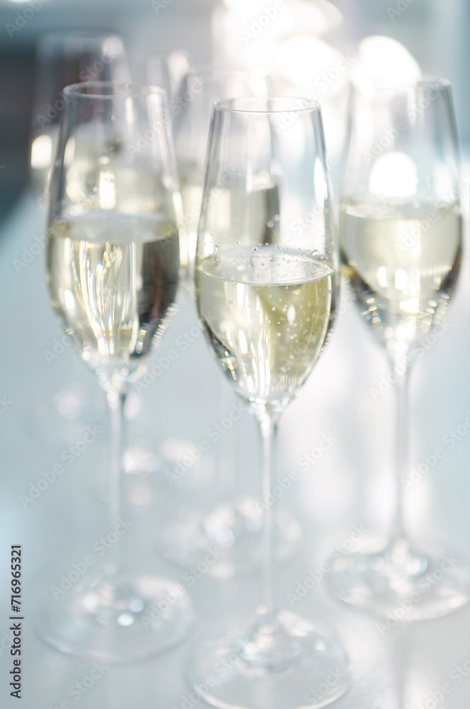 Champagne glasses on white background in bright lights