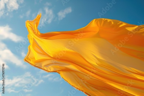A vibrant yellow cloth billowing in the wind on a sunny day. Perfect for adding a touch of color and movement to any design or project