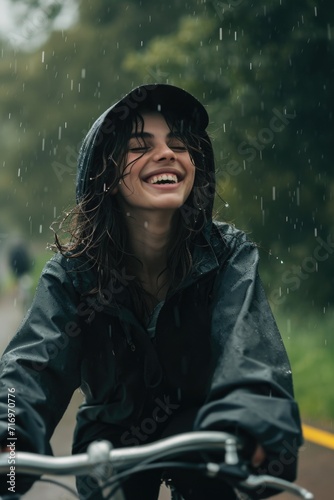 A woman riding a bike in the rain. Suitable for outdoor activities or weather-related concepts