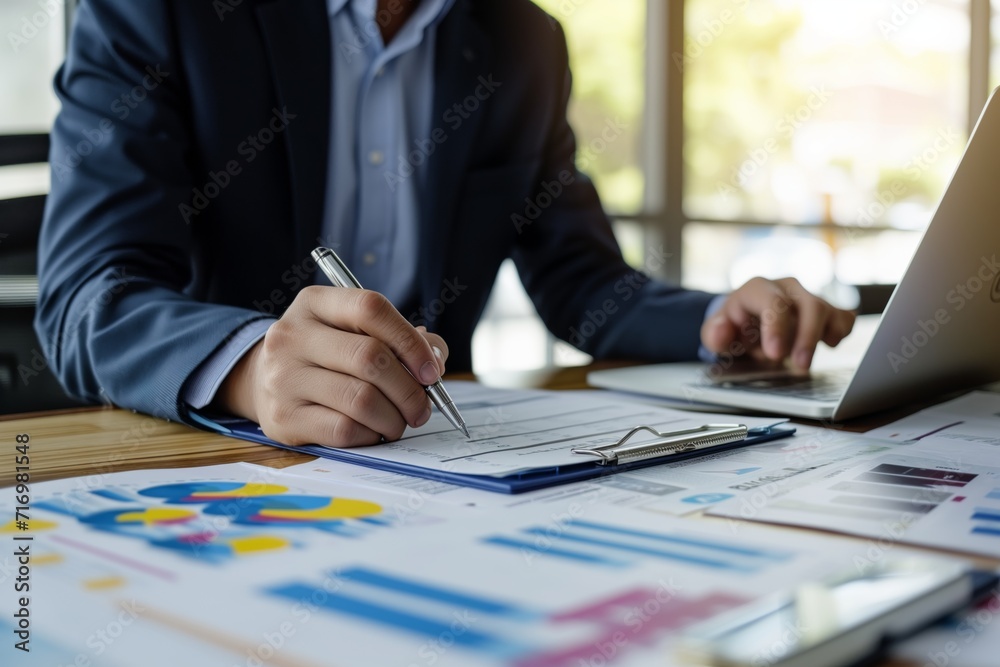 Asian Businessman Discussing Startup Project And Financial Data While Holding Note Paper Asian Businessman Discussing Startup Project And Financial Data While Holding Note Paper
