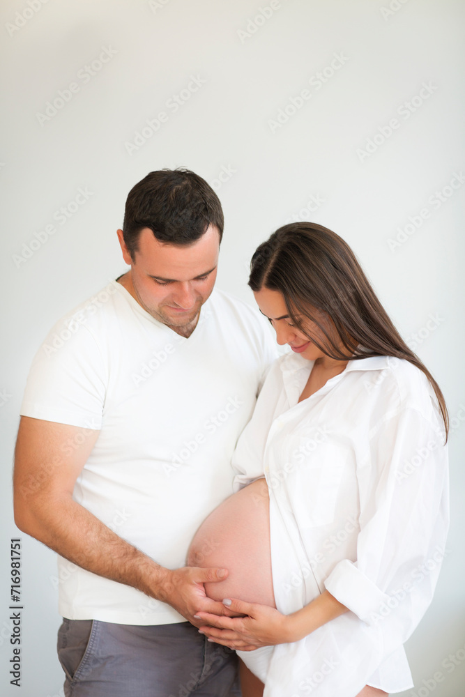 Pregnant woman and young man together indoors Pregnant woman and young man together indoors