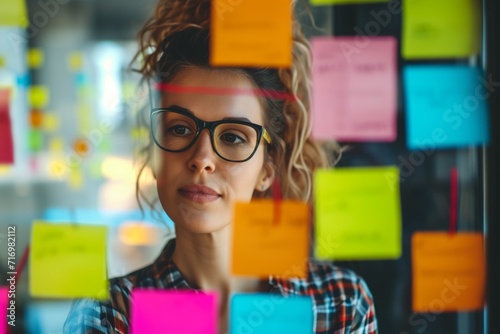 Businesswoman With Sticky Notes Creatively Planning In Confident, Youthful Office Setting