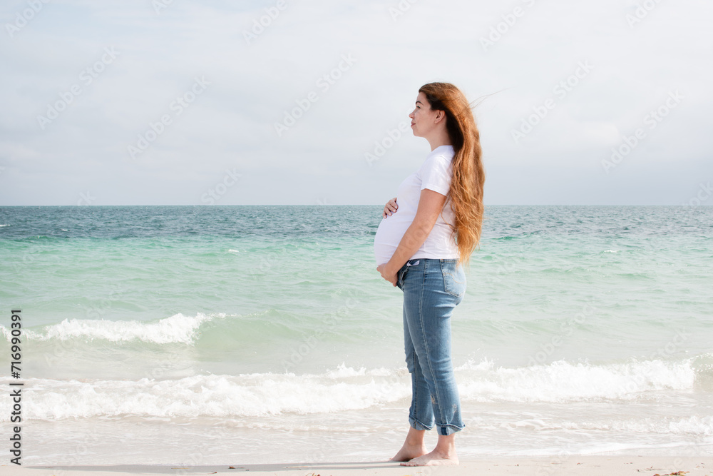 Pregnant woman enjoying the ocean. Pregnant woman on the beach. Happy healthy pregnancy.  wellness concept
