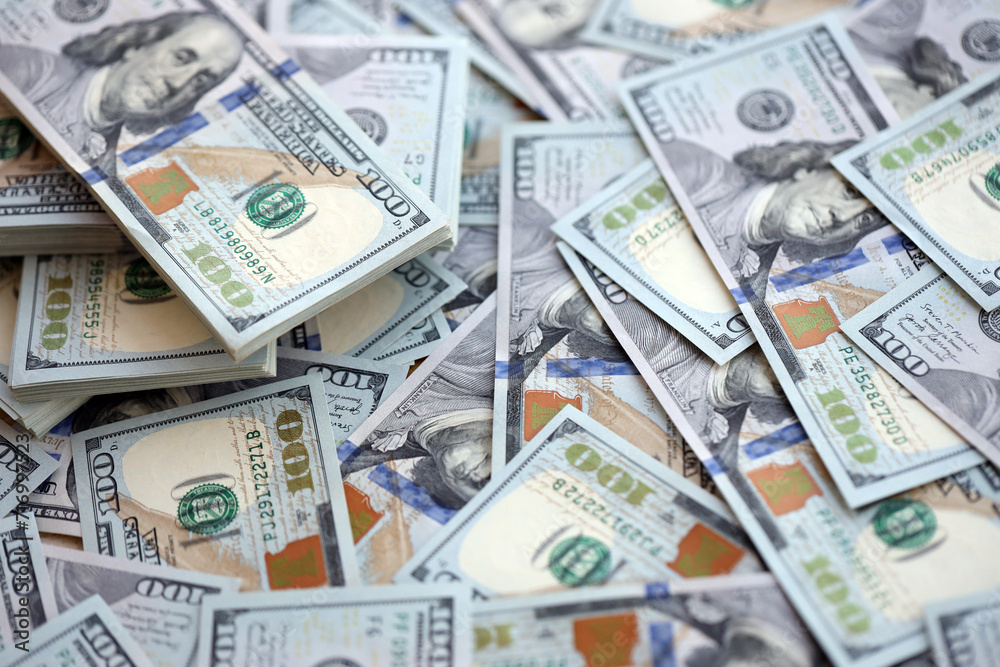 Very big amount of US hundred dollar bills close up. Huge quantity of united states currency notes on flat table Very big amount of US hundred dollar bills close up. Huge quantity of united states currency notes on flat table