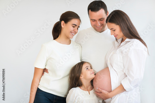 Happy pregnant woman with her husband and children