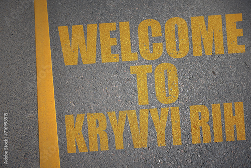 asphalt road with text welcome to Kryvyi Rih near yellow line. photo