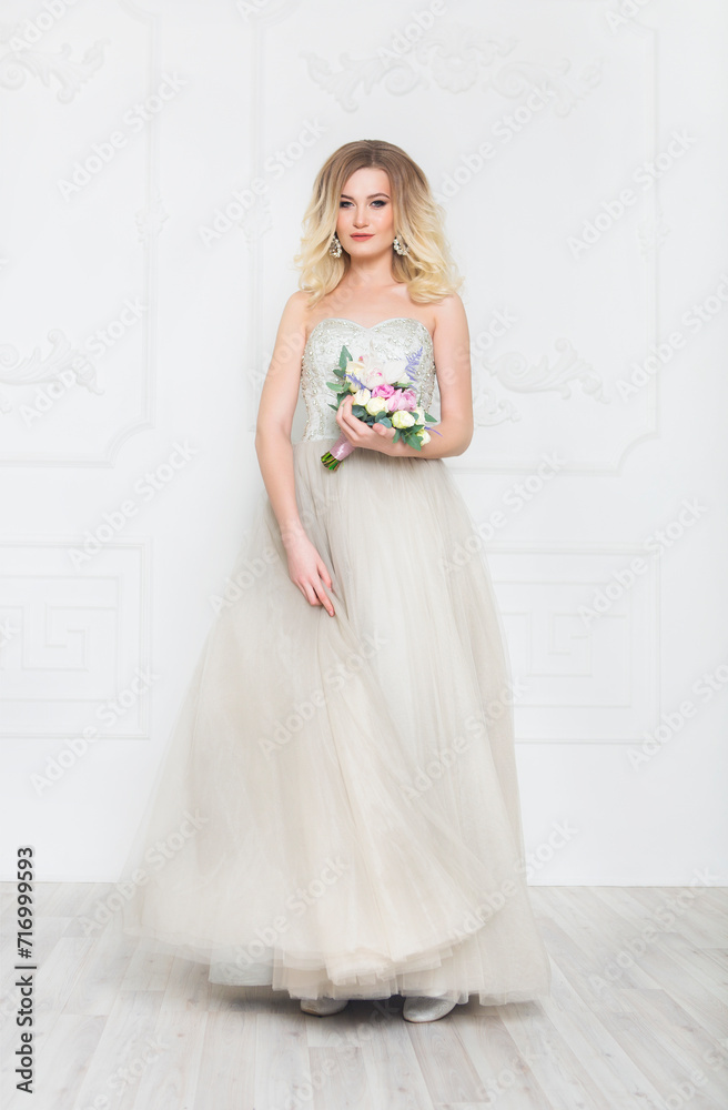 Young pretty bride with bridal bouquet indoors Young pretty bride with bridal bouquet indoors