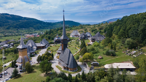 Aerial photography of Barsana monastery located in Maramures County, Romania. The landscape photography was taken from a drone at a lower altitude with the beautiful wooden monastery in the view.