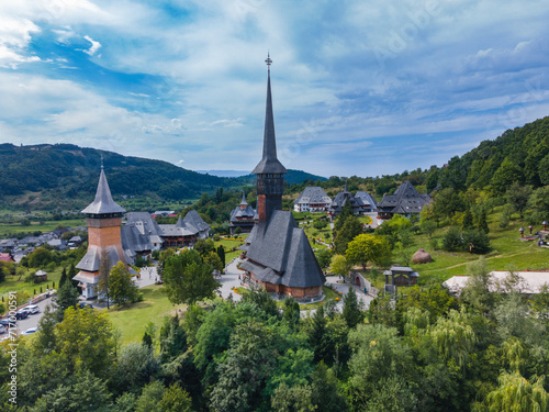 Aerial photography of Barsana monastery located in Maramures County, Romania. The landscape photography was taken from a drone at a higher altitude with the beautiful wooden monastery in the view.