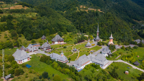Aerial photography of Barsana monastery located in Maramures County, Romania. Photography was taken from a drone at a higher altitude with camera tilted downwards for a top view shot of the monastery.