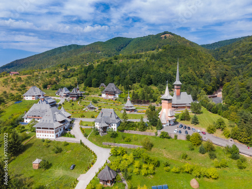 Aerial photography of Barsana monastery located in Maramures County, Romania. The landscape photography was taken from a drone at a higher altitude with the beautiful wooden monastery in the view.