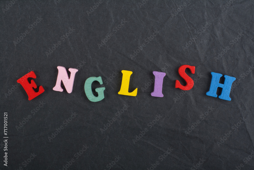 English word on black board background composed from colorful abc alphabet block wooden letters, copy space for ad text. Learning english concept. English word on black board background composed from colorful abc alphabet block wooden letters, copy space for ad text. Learning english concept.
