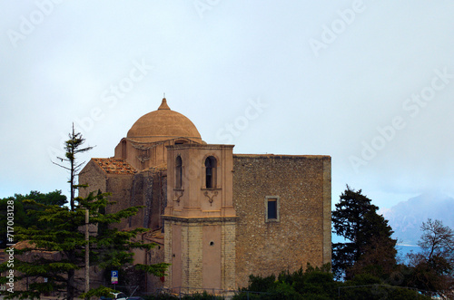 Scenic landscape view of ancient cobblestone San Goivanni church in Erice, Sicily, Italy. Blue sky background. Travel and tourism concept