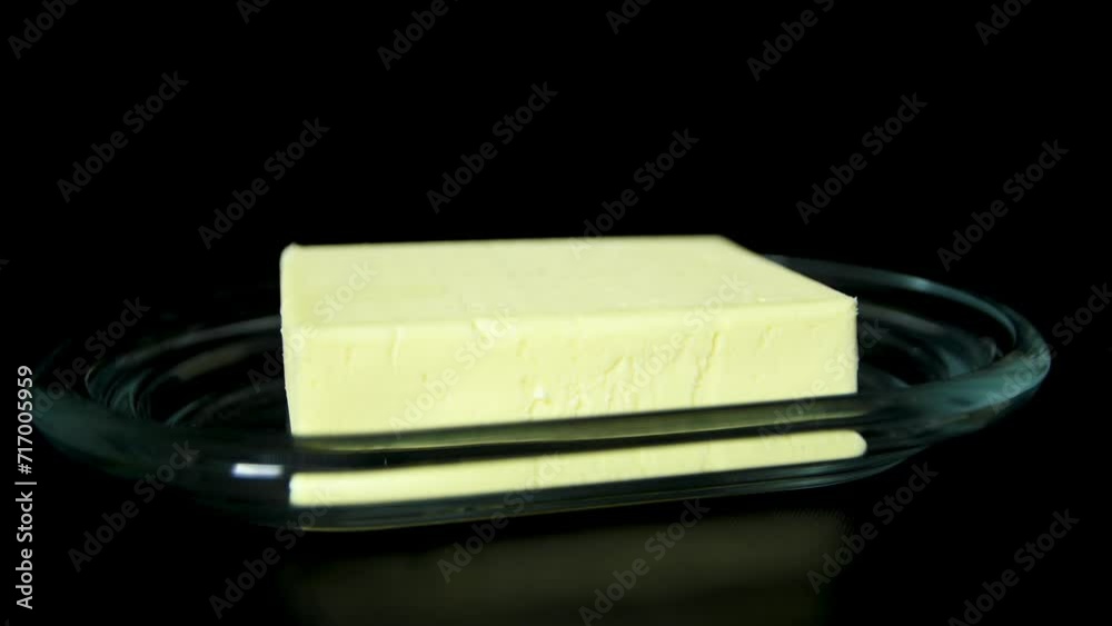 Butter bar on glass diary product on black background Butter bar on glass diary product on black background