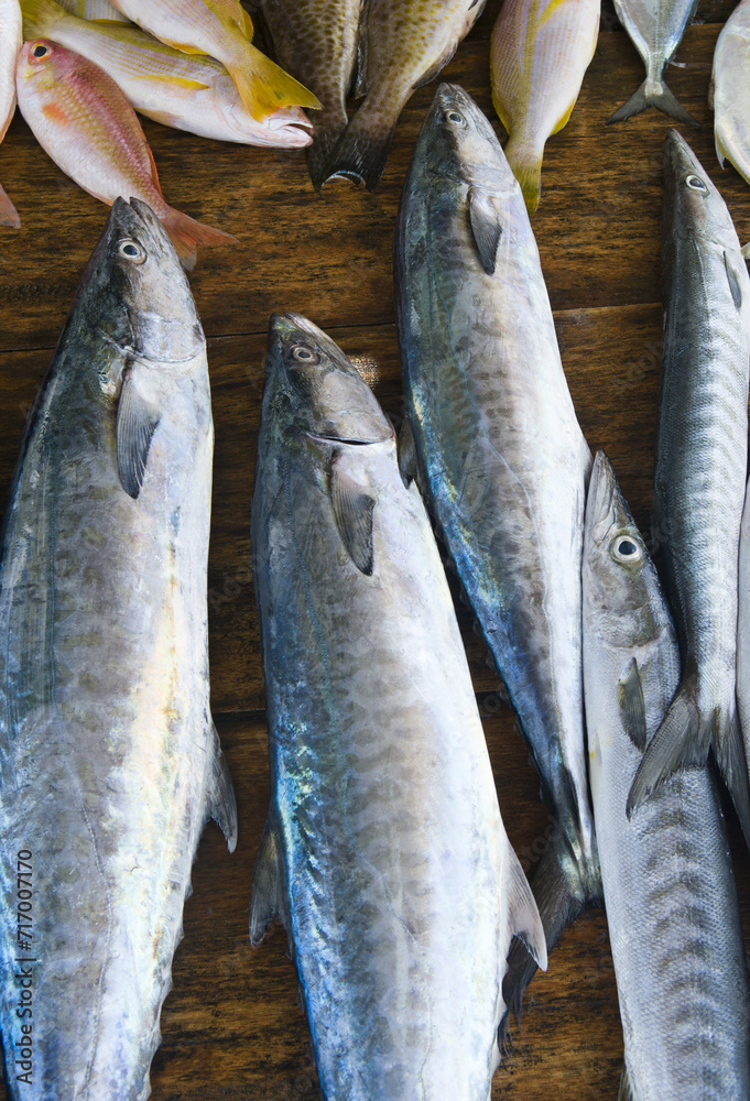 Fototapeta premium Freshly caught fish on the counter. Street market. Vertical photo.