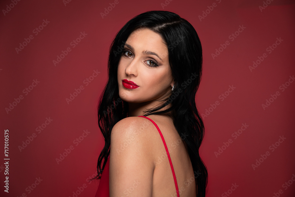 Beauty studio portrait of young beautiful woman against red background. Beauty studio portrait of young beautiful woman against red background.