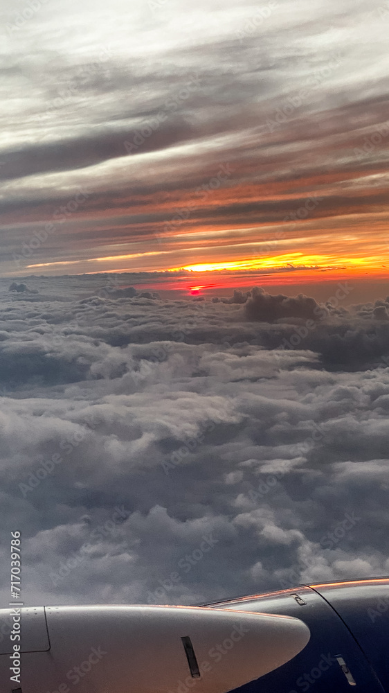 View from Airplane Window in Flight at Sunset