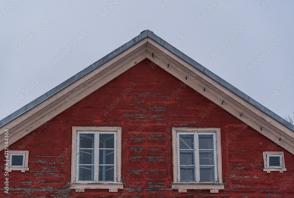 the roof ridge of a red old wooden house