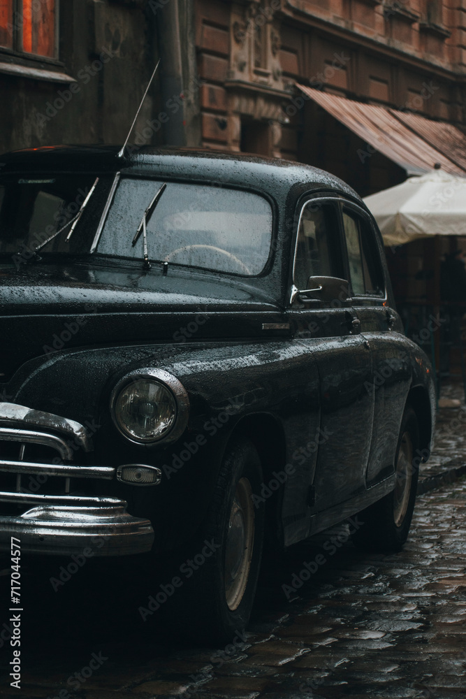 black retro car on the street of the old European city