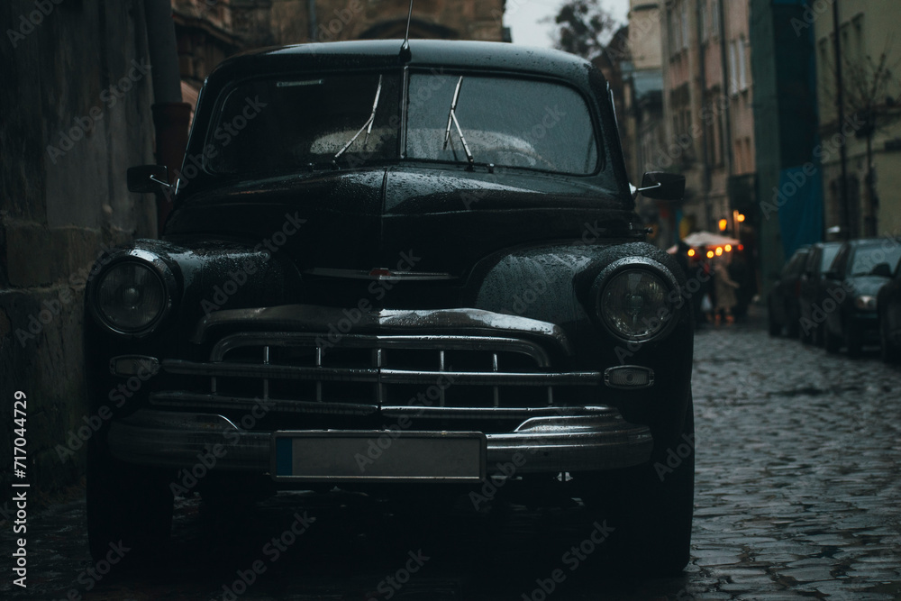 black retro car on the street of the old European city