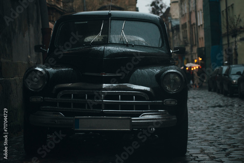 black retro car on the street of the old European city © Макс Босацький