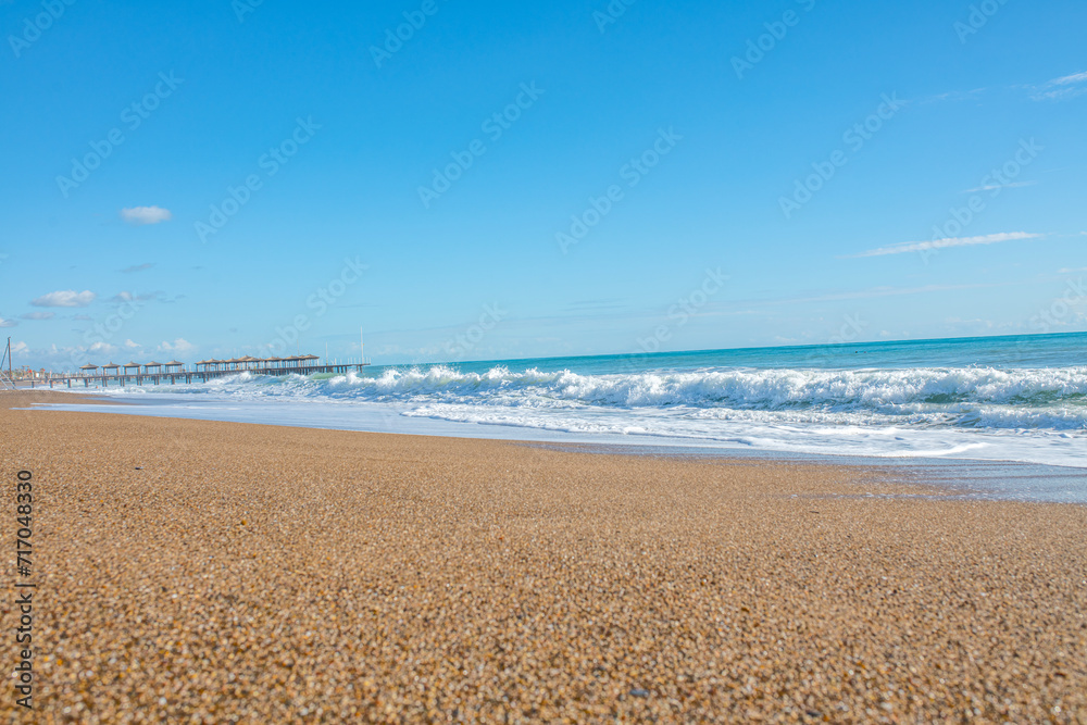 Fine beach sand in the summer sun.   Sand texture. Background of natural wavy sand . Sandy beach for background. Top view.