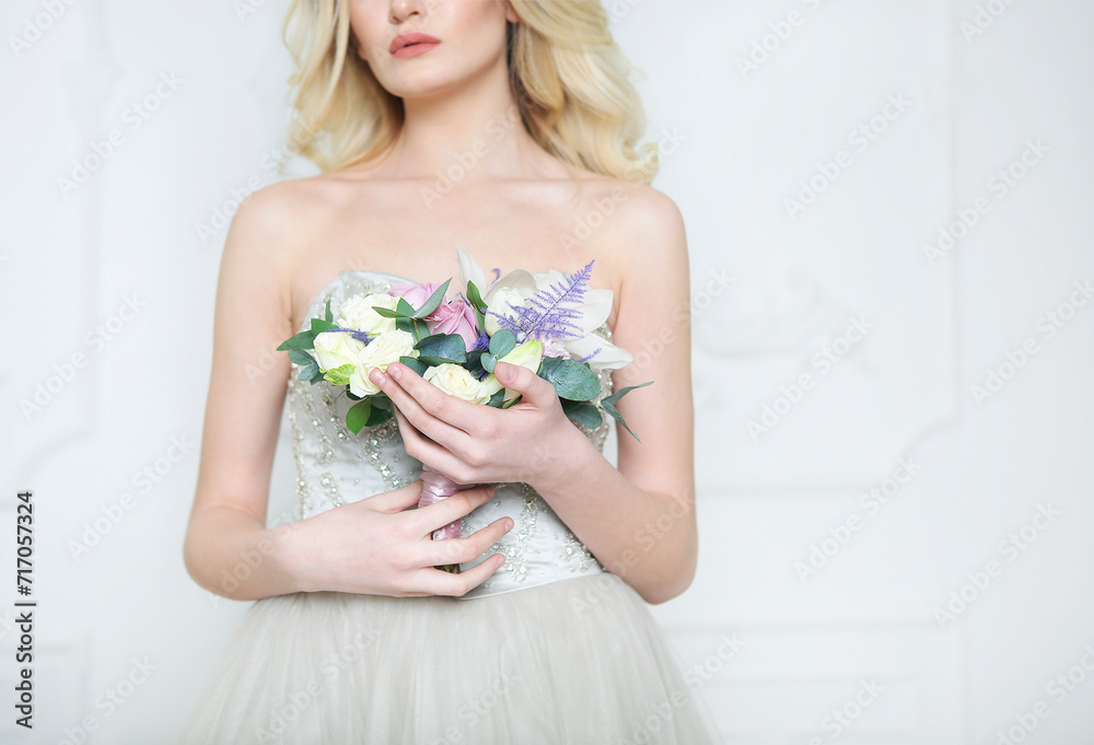 Young pretty bride with bridal bouquet indoors Young pretty bride with bridal bouquet indoors