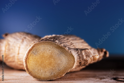A dry ginger root is photographed in close-up on a beautiful background