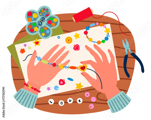 Beads bracelet hand made. Top view on table with hands making beads bracelets. Cute bangle beads , children's jewelry,DIY. Kids necklace hand made. Cartoon vector illustration on white background.