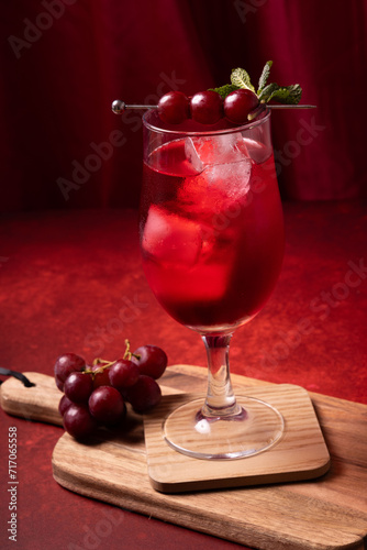 glass of cherry juice with fresh red grapes