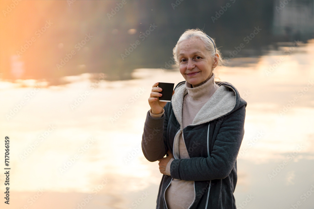 A woman, lady drinks a coffee and enjoys the sunset. A woman, lady drinks a coffee and enjoys the sunset.