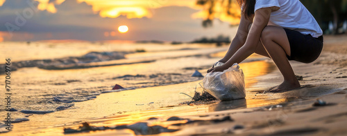 Young woman picking plastic bottle into trash plastic bag for cleaning the beach, Ecology concept and World Environment Day, Save earth concept