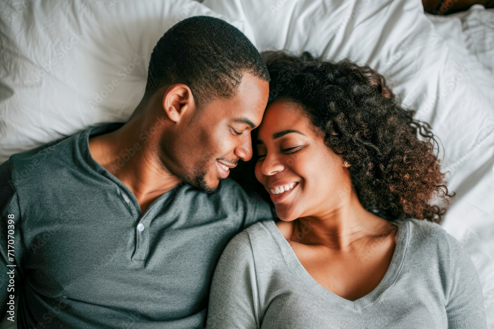 Smiling couple on bed, time to family, concept family Smiling couple on bed, time to family, concept family