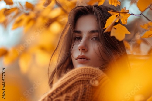 Beautiful model with autumn leaves and fall yellow garden backgr