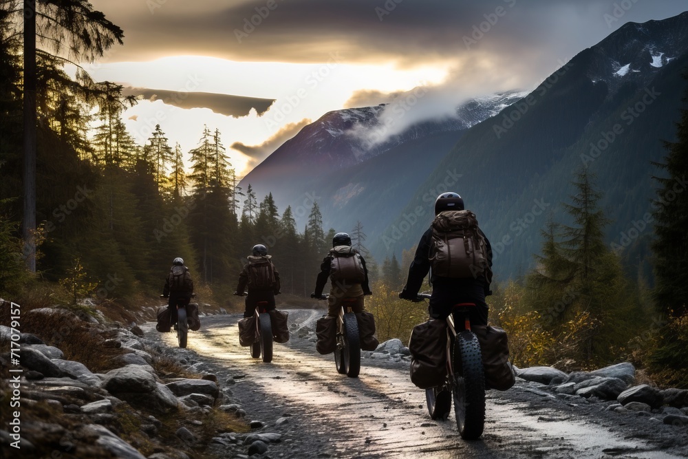 Breathtaking sunset mountain landscape with a group of adventurous cross country bikers riding
