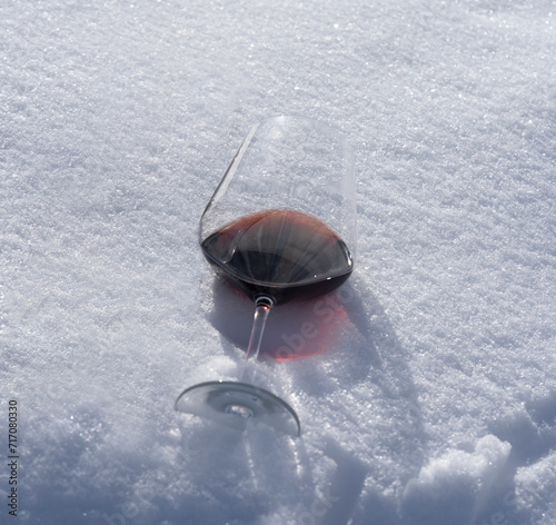 a wine glass is sitting in the snow