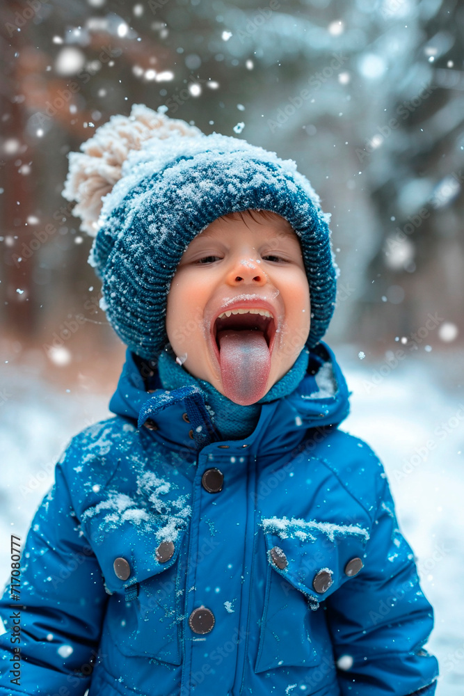 A child catches snow with his tongue on the street. Selective focus. A child catches snow with his tongue on the street. Selective focus.