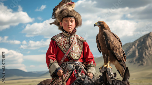 Traditional kazakh eagle hunter girl with her golden eagle that is used to hunt for fox and rabbit fur, Western Mongolia.