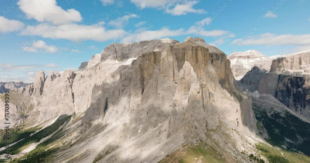 Dolomites mountains Italy Alps at dawn on sunny day in summer against blue sky. Grandeur mountain range. Aerial view panning shot of beautiful Dolomite Mountain range. Tavel tourism concept Dolomites mountains Italy Alps at dawn on sunny day in summer against blue sky. Grandeur mountain range. Aerial view panning shot of beautiful Dolomite Mountain range. Tavel tourism concept