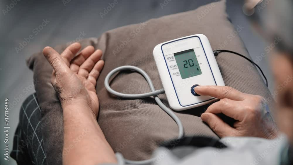 Aged man using blood pressure monitor at home, closeup view, checking health conditions daily Aged man using blood pressure monitor at home, closeup view, checking health conditions daily