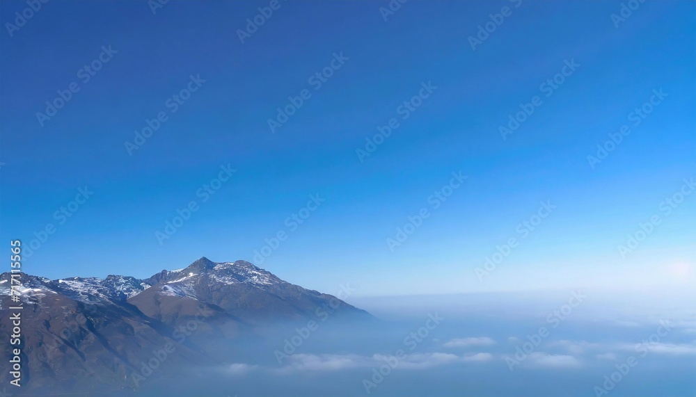 Mountain top above fog and clear sky.
