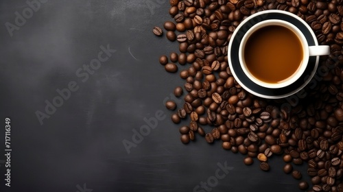 Top view of coffee beans and coffee cup on dark table © Voilla