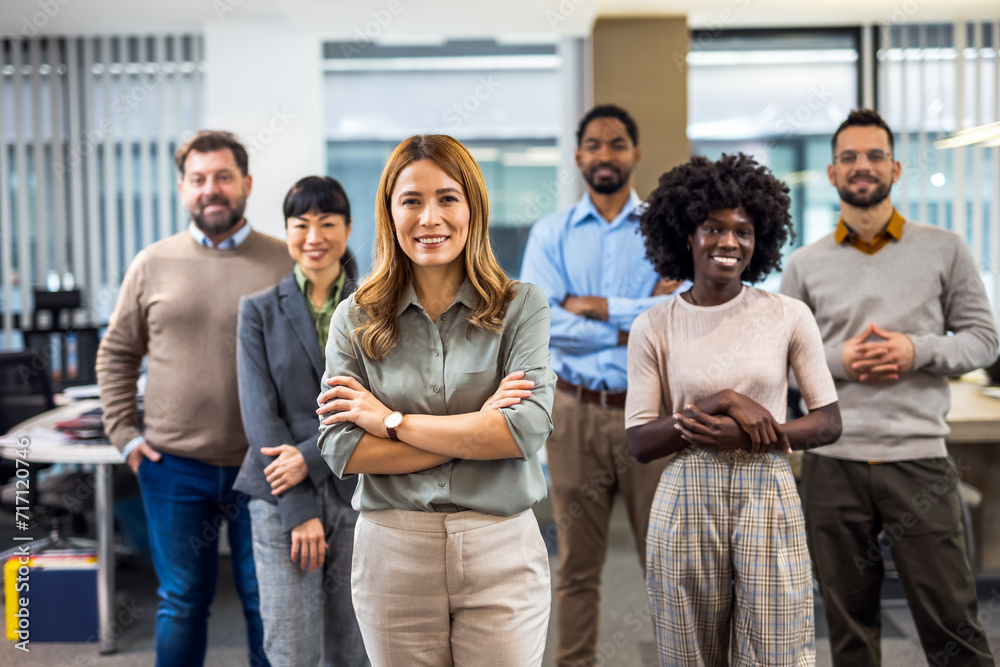 Fototapeta premium Cucasian boss standing in front of her colleagues in the office