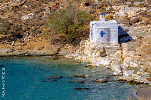 Tiny white church by the sea on Tinos Island, Greece photo