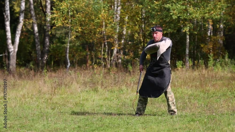 Men is dog trainer with whip and protection on hand teach doberman Men is dog trainer with whip and protection on hand teach doberman