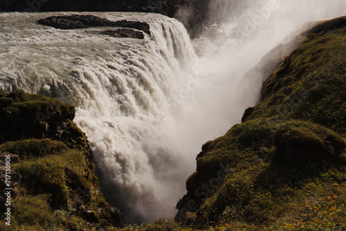 Traveling and exploring Iceland landscapes and famous places. Autumn tourism by Atlantic Ocean and mountains. Outdoor views on beautiful cliffs and travel destinations. Gullfoss waterfall.