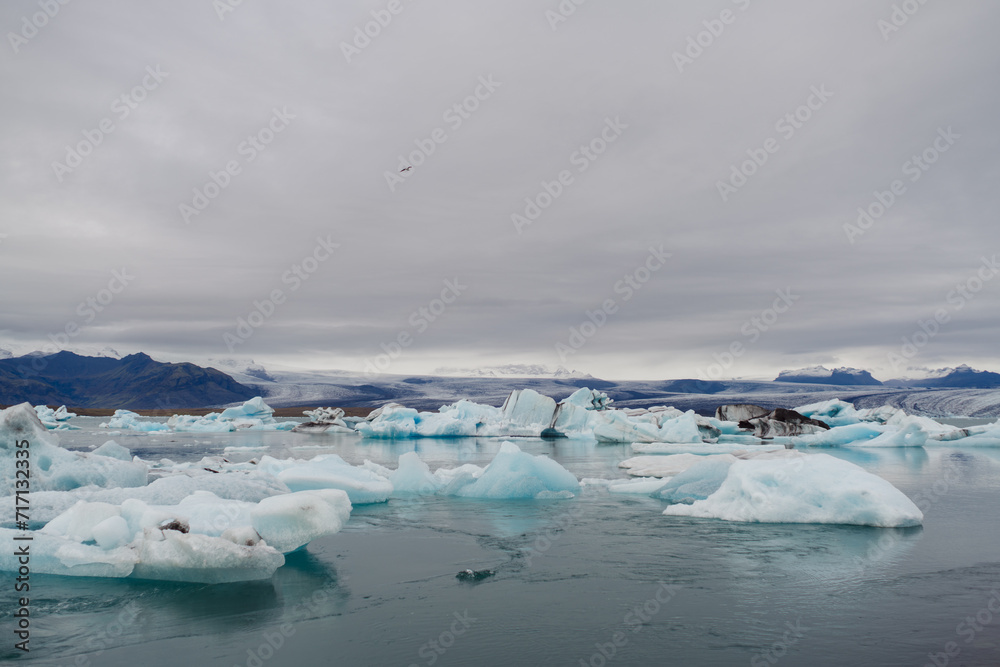 Traveling and exploring Iceland landscapes and famous places. Autumn tourism by Atlantic ocean and mountains. Outdoor views on beautiful cliffs and travel destinations. Jökulsárlón Glacier Lagoon.
