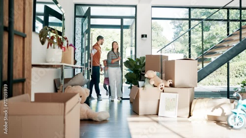 Family moving, new home and children running with parents excited for mortgage and real estate. Happy father, mother and kids walking in front door with boxes for dream house, property and investment photo