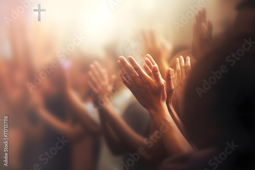 Soft focus of Christian worship with raised hand,m