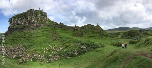 Landscape around Faerie Castle (Castle Ewen) at Fairy Glen in Isle of Skye in Scotland, UK with unrecognizable tourists